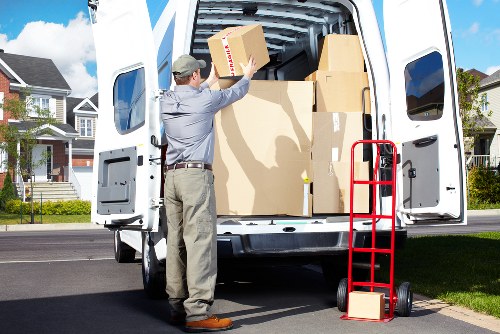 Staff separating recyclable materials in line with borough waste systems